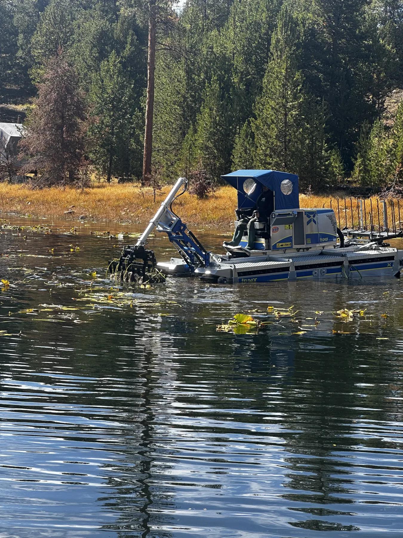Aquatic harvesting operation in Utah with amphibious equipment
